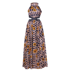 Elegant halter-neck maxi dress featuring the vibrant Tshwane Sunflower print in mustard and navy tones, with a cinched waist and flowing silhouette.