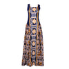 A bold geometric Tshwane print maxi dress featuring a fitted sleeveless bodice in navy with mustard accents and a flared skirt with intricate patterns in earthy tones. The dress combines structured elegance with flowing gathers, perfect for a statement look.